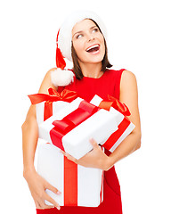 Image showing woman in santa helper hat with many gift boxes