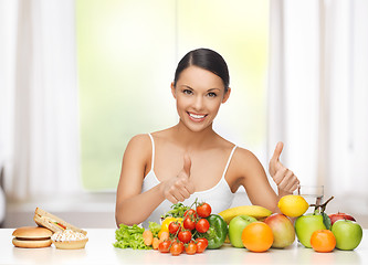 Image showing woman with fruits rejecting junk food