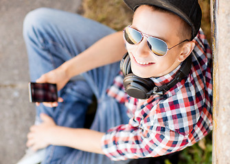 Image showing girl with headphones and smartphone