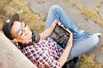 Image showing girl with headphones and tablet pc