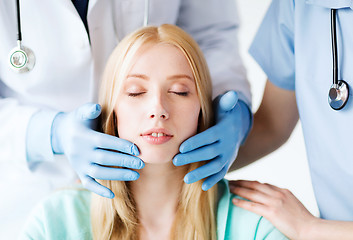 Image showing plastic surgeon or doctor with patient