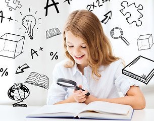 Image showing girl reading book with magnifier at school