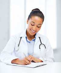 Image showing female doctor writing prescription