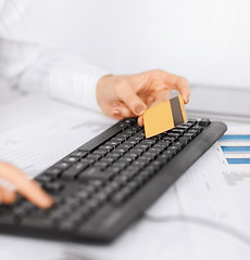 Image showing businesswoman with laptop using credit card