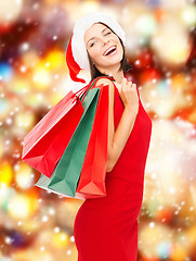 Image showing woman in red dress with shopping bags