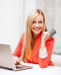 Image showing businesswoman with laptop using credit card