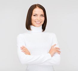 Image showing smiling woman in white sweater