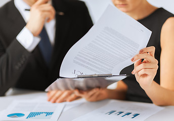 Image showing man and woman signing contract paper