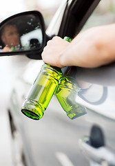 Image showing man drinking alcohol while driving the car