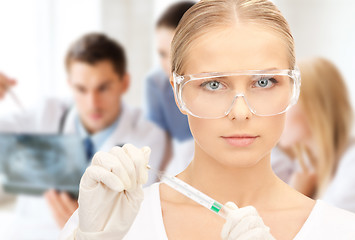 Image showing scientist holding thermometer