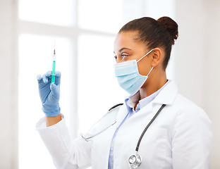 Image showing african doctor holding syringe with injection