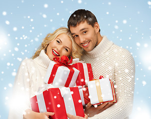 Image showing happy man and woman with many gift boxes