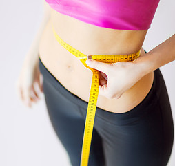 Image showing trained belly with measuring tape