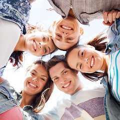 Image showing group of teenagers looking down