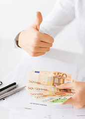 Image showing woman hands with euro cash money and thumbs up