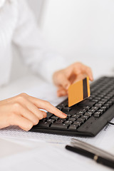 Image showing businesswoman with laptop using credit card