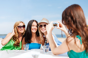 Image showing girls taking photo in cafe on the beach