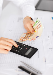 Image showing woman hand with calculator and euro money