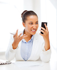 Image showing african woman shouting into smartphone