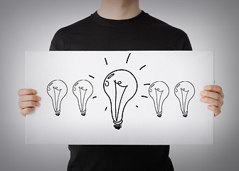 Image showing man showing picture with light bulbs