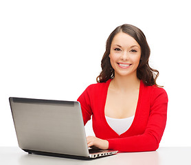 Image showing smiling woman in red clothes with laptop computer