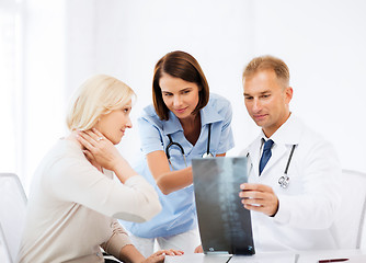 Image showing doctors with patient looking at x-ray