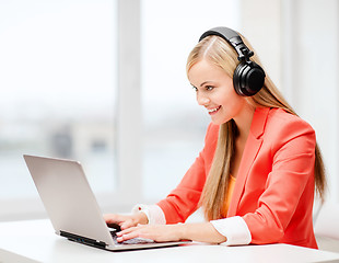 Image showing happy woman with headphones listening to music