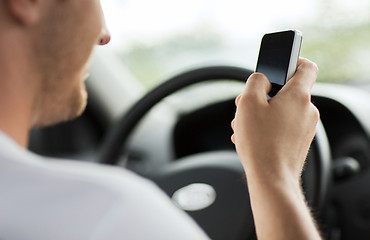 Image showing man using phone while driving the car