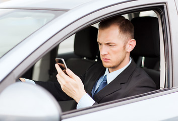 Image showing man using phone while driving the car