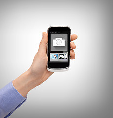 Image showing hand with smartphone showing application