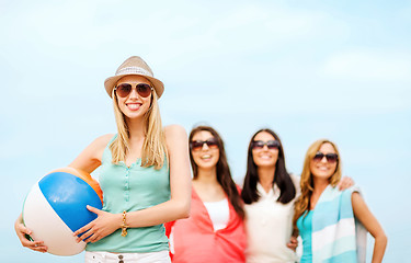 Image showing girl with ball and friends on the beach