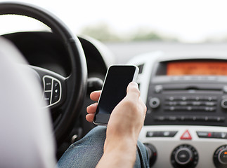 Image showing man using phone while driving the car