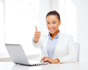 Image showing businesswoman with laptop showing thumbs up