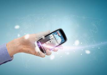 Image showing hand showing smartphone with news app