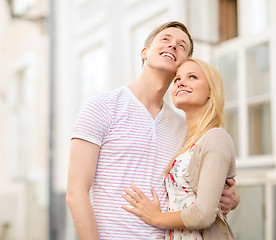 Image showing romantic couple in the city looking up