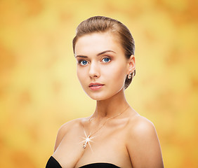 Image showing woman wearing shiny diamond earrings and pendant