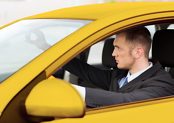 Image showing businessman or taxi driver driving a car