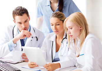 Image showing group of doctors looking at tablet pc