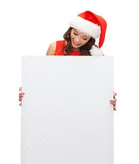 Image showing woman in santa helper hat with blank white board