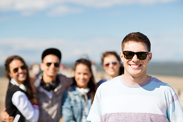 Image showing teenager in shades outside with friends