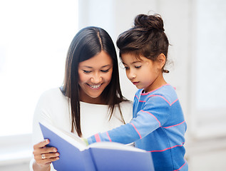 Image showing mother and daughter with book