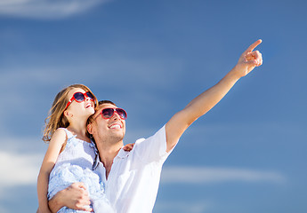 Image showing happy father and child in sunglasses over blue sky