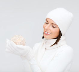 Image showing woman in hat and gloves with christmas ball