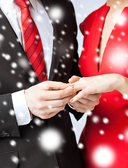 Image showing man putting wedding ring on woman hand