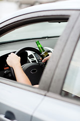 Image showing man drinking alcohol while driving the car