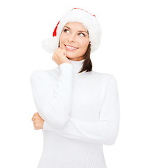 Image showing thinking and smiling woman in santa helper hat