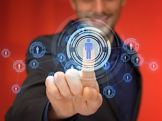 Image showing businessman pressing button with contact