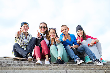 Image showing group of teenagers showing finger five