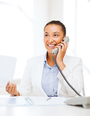 Image showing african businesswoman with phone in office