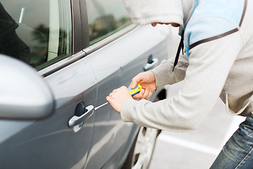 Image showing thief breaking the car lock